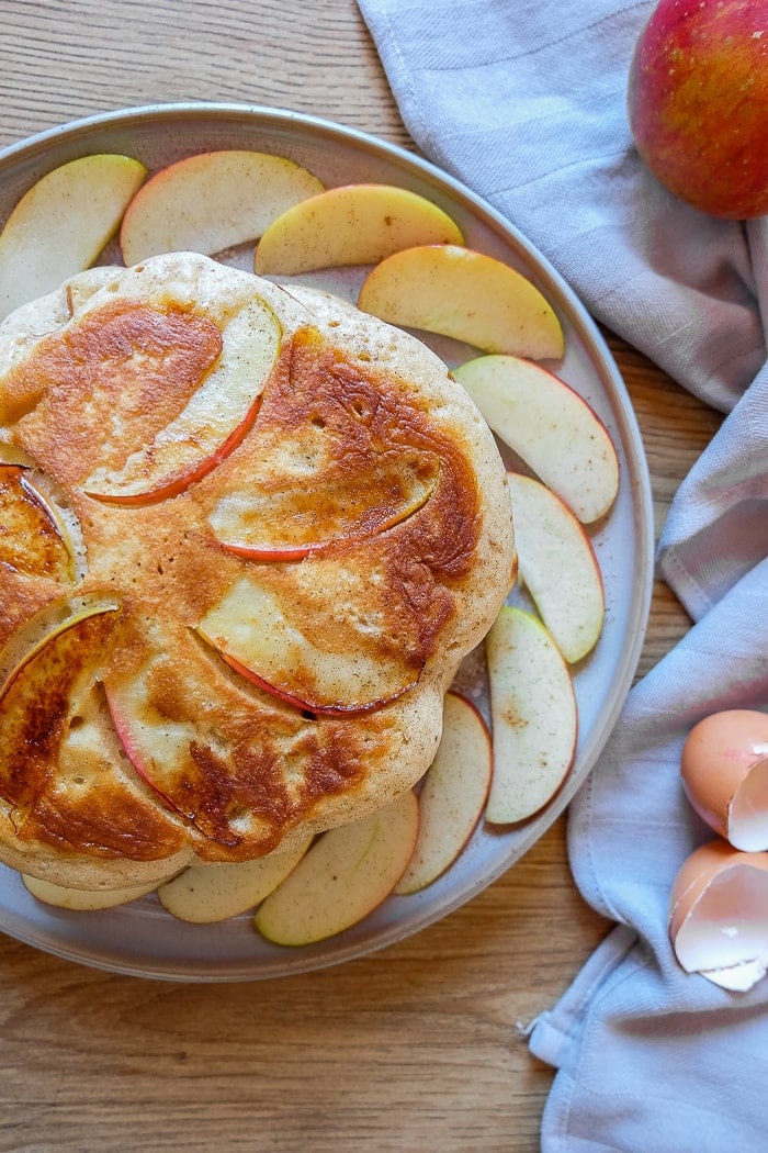 round apple pancakes on plate with apple slices and napkin around