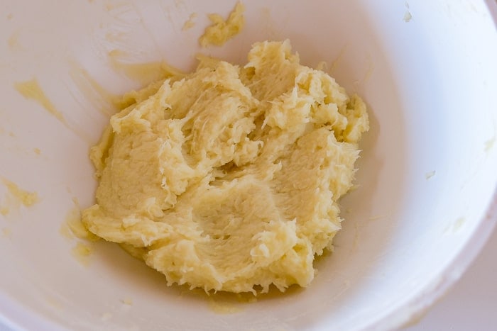 mixed raw and cooked potato in mixing bowl for dumplings