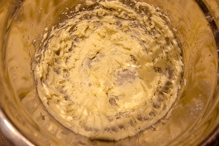 white ingredients mixed in a metallic mixing bowl