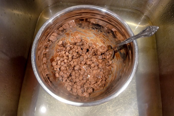 chocolate chips melting in metal bowl