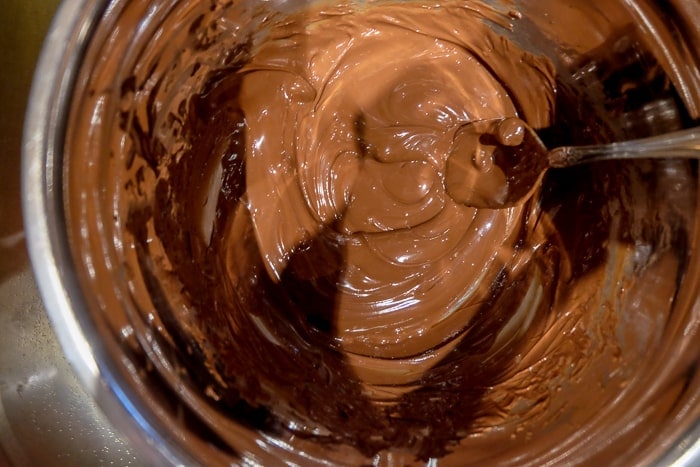 melted chocolate in a bowl with silver spoon