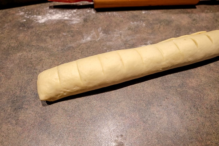 rolled cinnamon roll dough on cooking counter