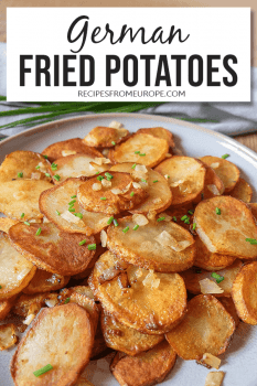 Plate full of fried potatoes garnished with chives and onions with text overlay saying German fried potatoes