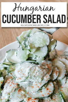 Bowl full of cucumber salad with paprika and sour cream and spoon in background plus text overlay saying Hungarian cucumber salad