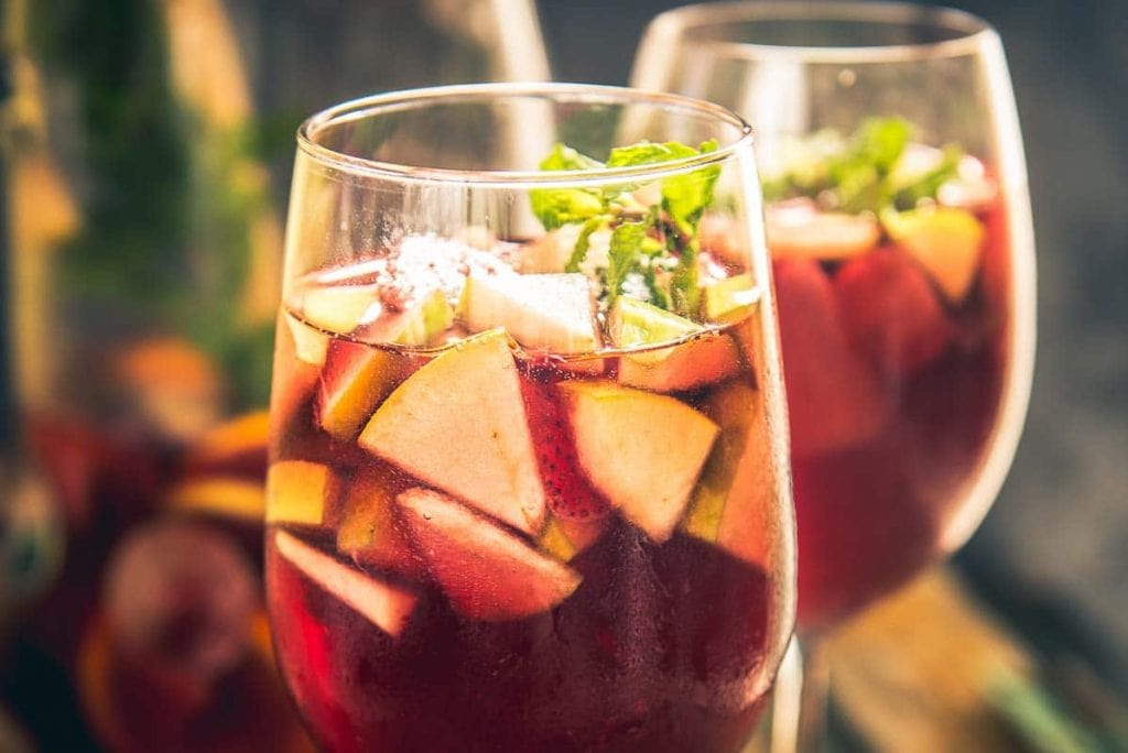 Red sangria in tall glasses with fruit. 