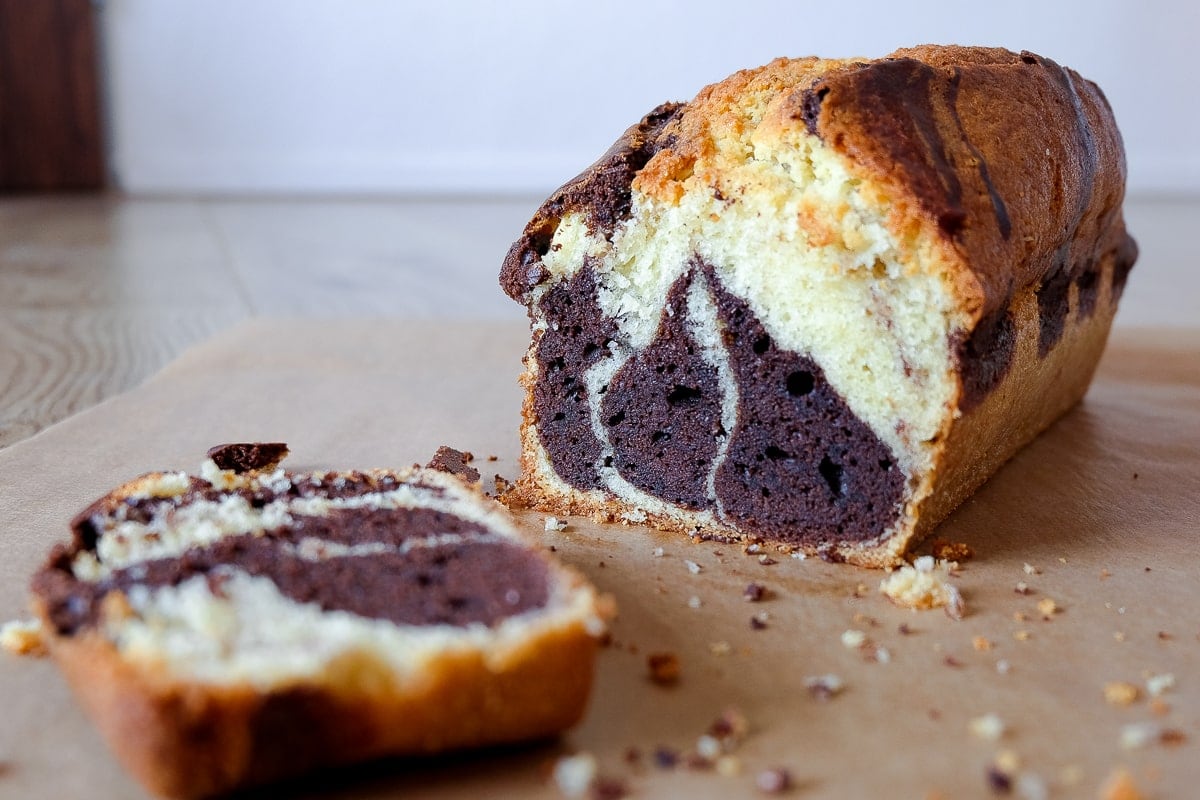 marble cake cut with slice on parchment paper