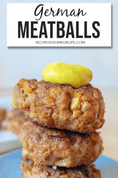 stack of meatballs with mustard on blue plate and text overlay saying German meatballs