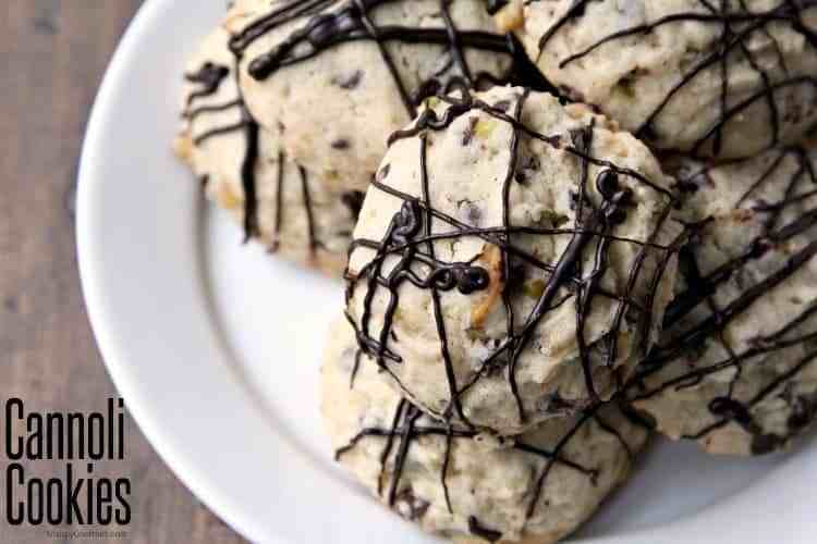 round cookies with chocolate drizzled on top on white plate.