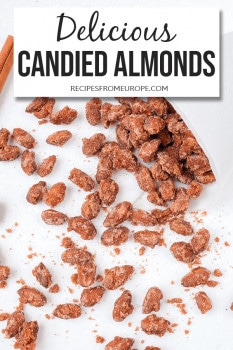 Photo of candied almonds on white surface with text overlay saying delicious candied almonds