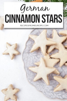 Cinnamon star cookies on purple plate with text overlay saying German cinnamon stars