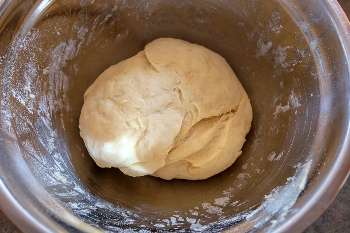 risen german Franzbrötchen dough in metal bowl