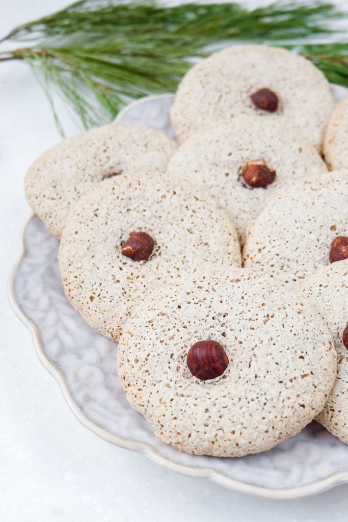 german hazelnut cookies with nut in middle on festive plate