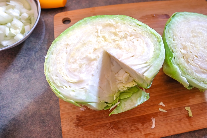 green cabbage with core removed on cutting board