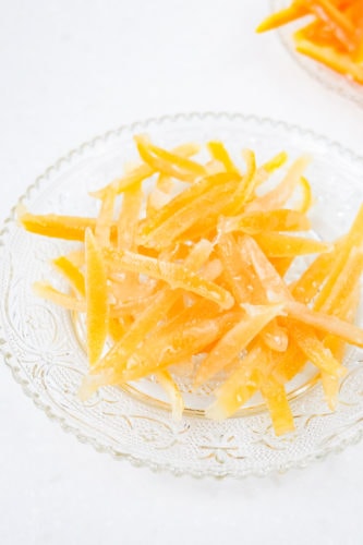 clear plate of candied lemon peels on white counter
