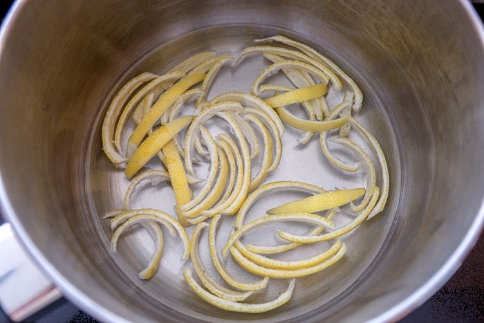 lemon peels in metallic pot on stove