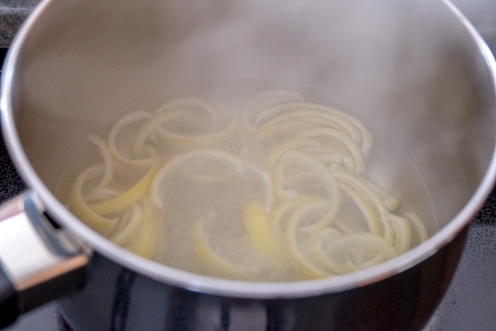 lemon peels in steaming metal pot on stove