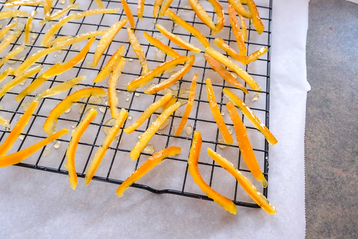 candied orange peels on cooling rack on counter top