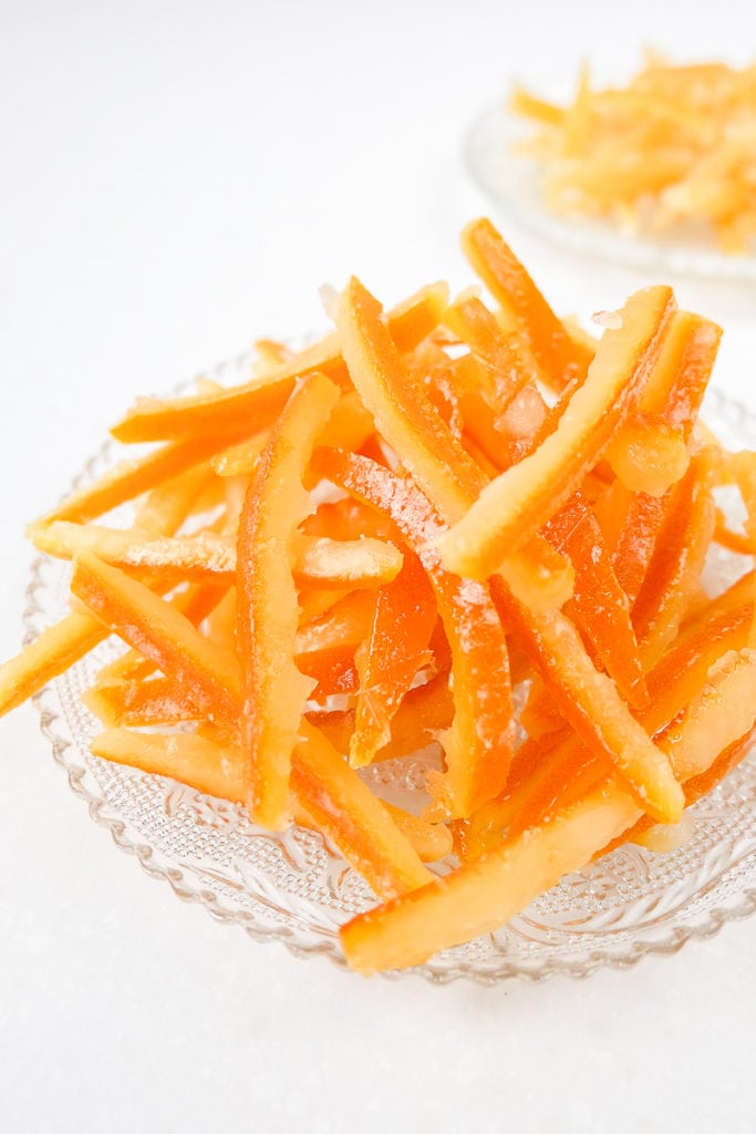 clear plate of candied orange peel on white counter