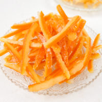 candied orange peel on clear plate on white counter