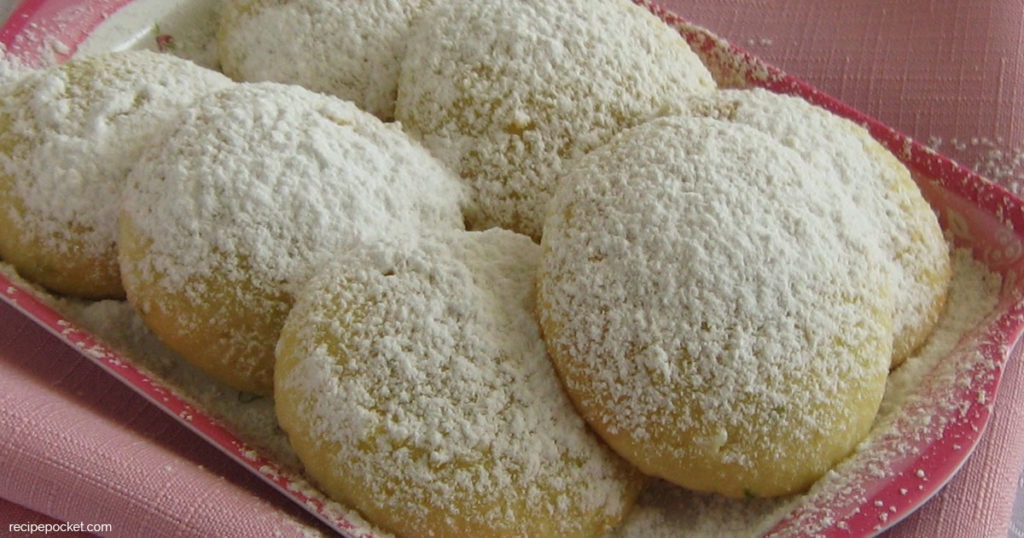 round cookies with icing sugar on top on platter. 