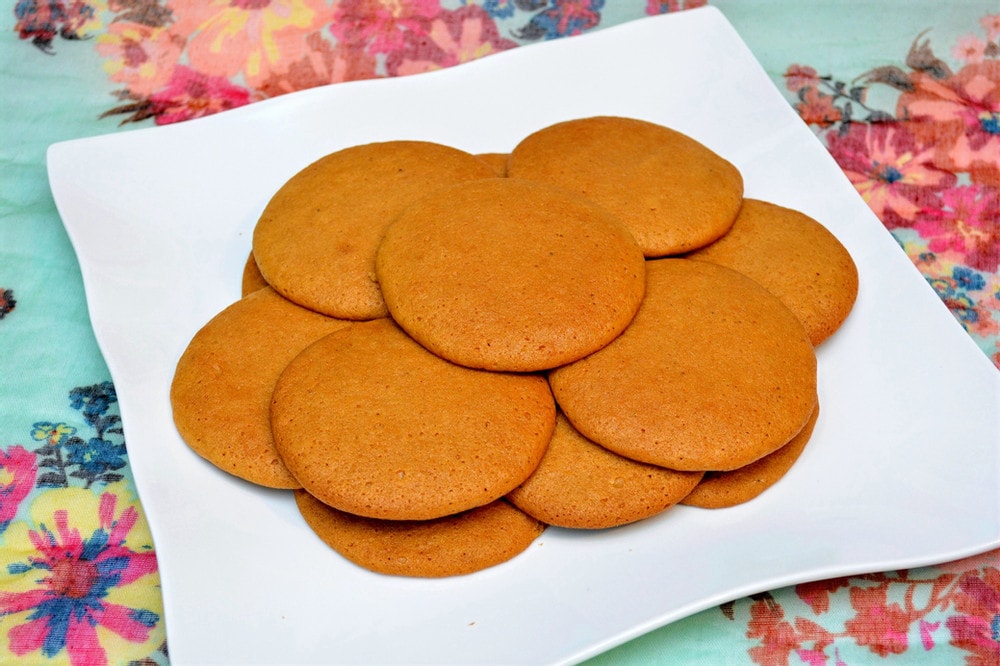 round brown cookies on white plate. 