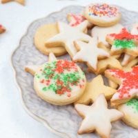 colorful german butter cookies with icing and sprinkles on plate