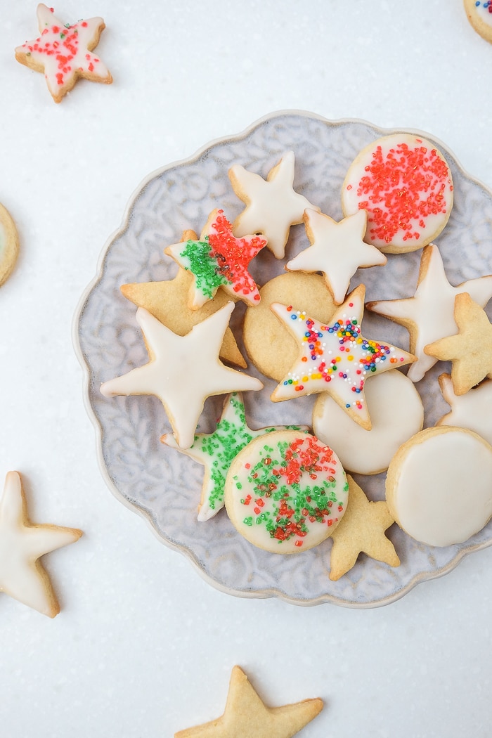 german butter cookies on festive plate with decorative icing and sprinkles