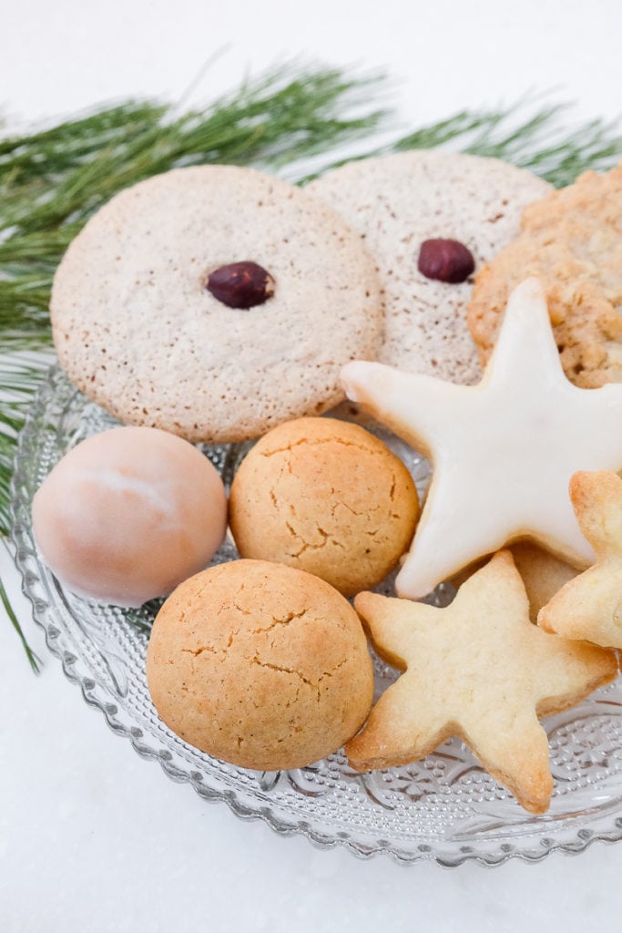 plate of german christmas cookies on white counter