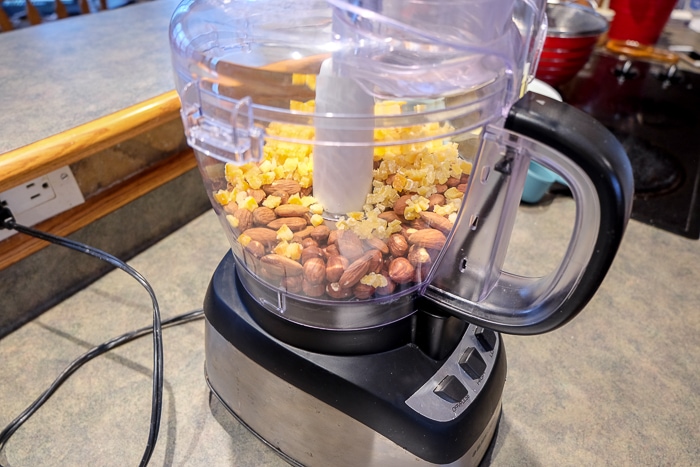 full food processor with nuts and fruit inside
