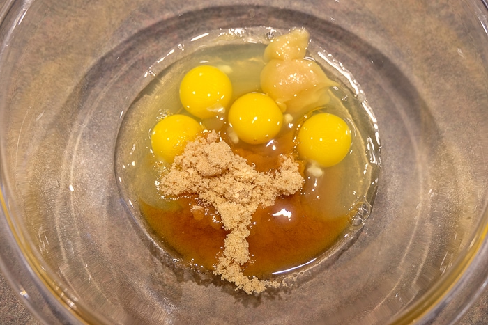 eggs and dry ingredients in clear mixing bowl on counter