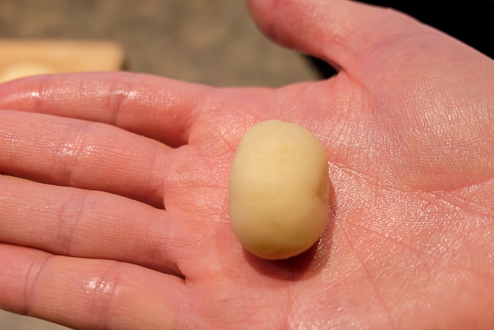 small marzipan potato ball in palm of hand