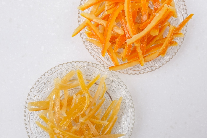 candied lemon and orange peels on plates on white counter