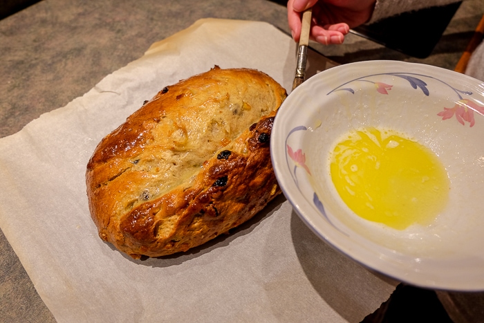bowl of melted butter above load of german stollen christmas bread
