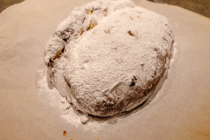 german stollen covered in thick layer of icing sugar