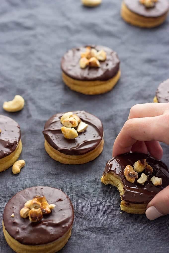 round cookies with chocolate top and nuts on top. 