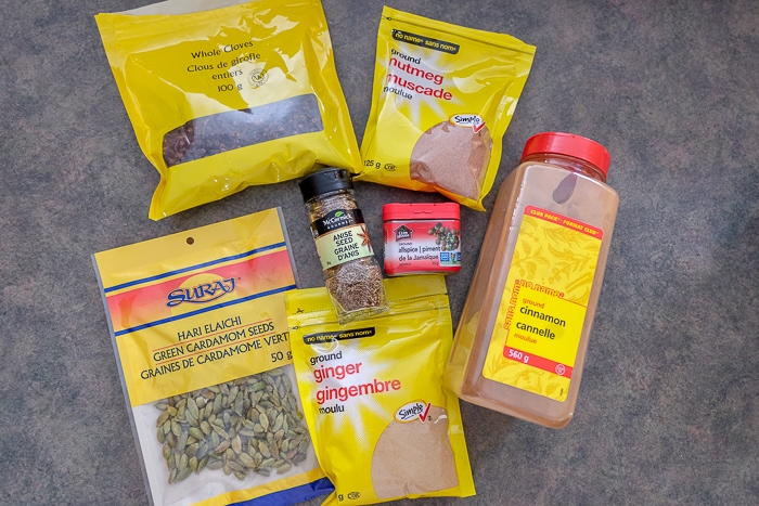 various yellow packages of assorted spices on counter for gingerbread spice