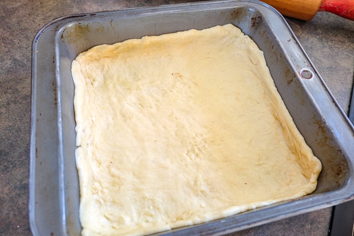 dough in bottom of baking pan for hungarian apple pie