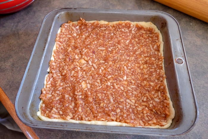 hungarian apple pie filling in dough in pan