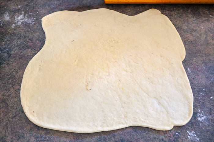 square of dough rolled out on counter
