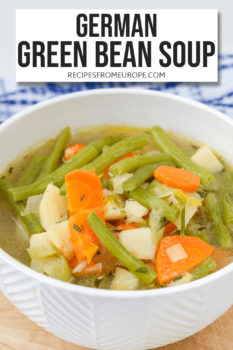 Photo of green bean soup in white bowl with text overlay saying German green bean soup