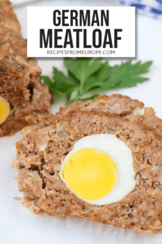 Photo of slice of meatloaf with boiled egg inside on plate and text overlay saying German meatloaf