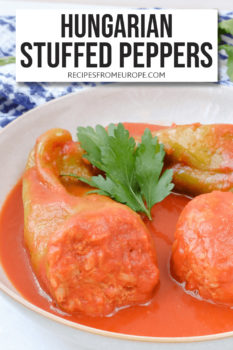 Stuffed peppers with tomato sauce in bowl and text overlay saying Hungarian stuffed peppers