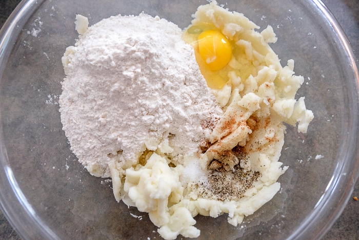 egg and dry ingredients in clear glass bowl