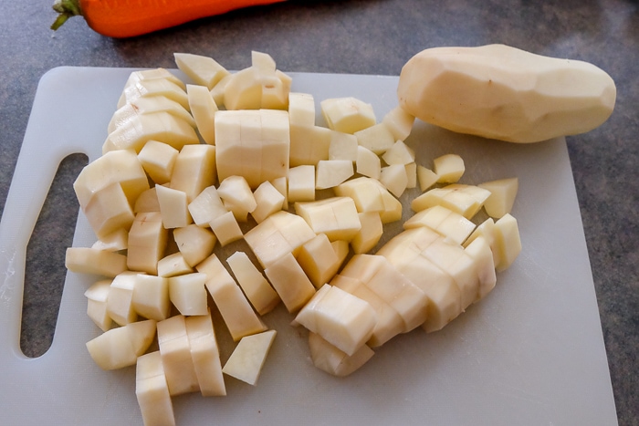 potatoes chopped up on white plastic cutting board
