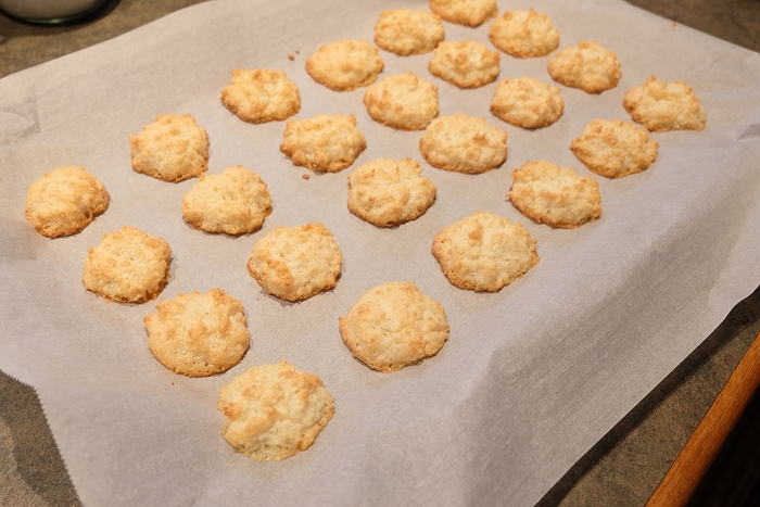 baked coconut macaroons on baking sheet with parchment paper