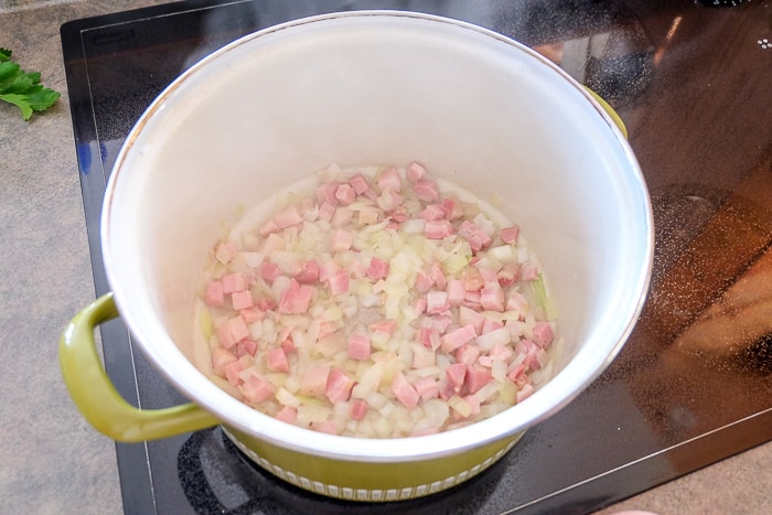 ham and onions cooking in soup pot on stove top