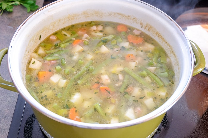 german green bean soup cooked in large green soup pot