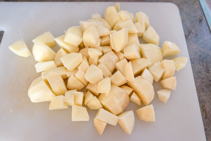 potatoes chopped up on white cutting board