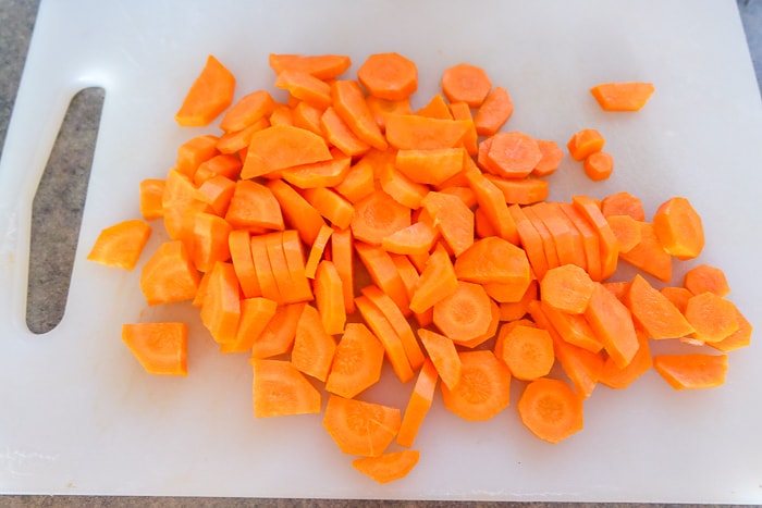 sliced orange carrots on white plastic cutting board