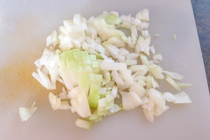 chopped onion on white plastic cutting board